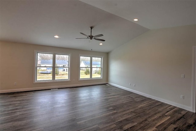 spare room with ceiling fan, vaulted ceiling, and dark hardwood / wood-style floors