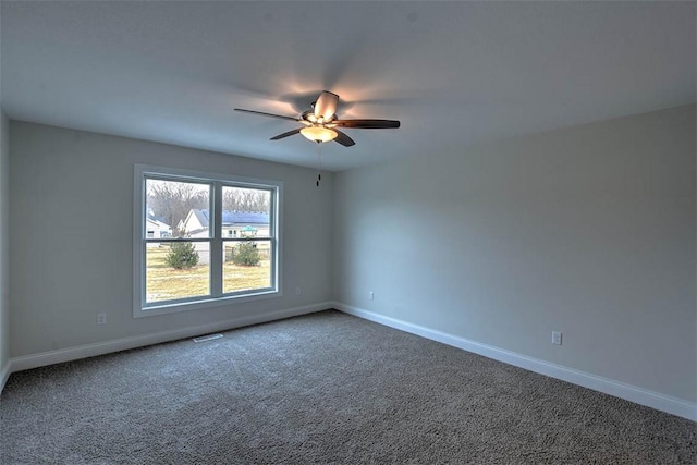 empty room with ceiling fan and carpet floors