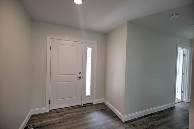 unfurnished living room featuring dark wood-type flooring, lofted ceiling, and ceiling fan with notable chandelier