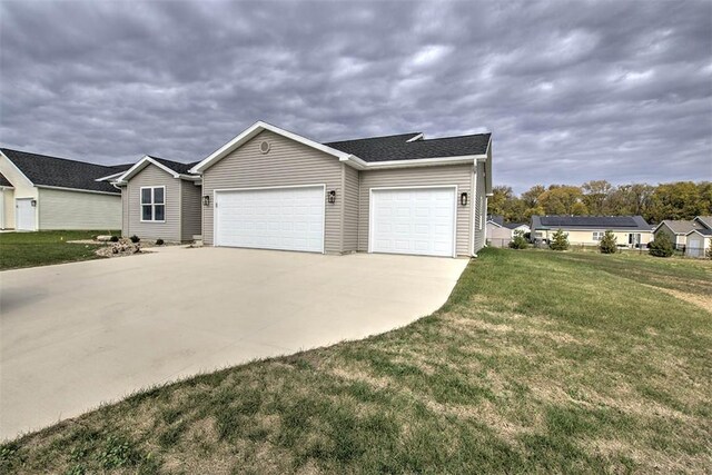 ranch-style home featuring a front yard and a garage