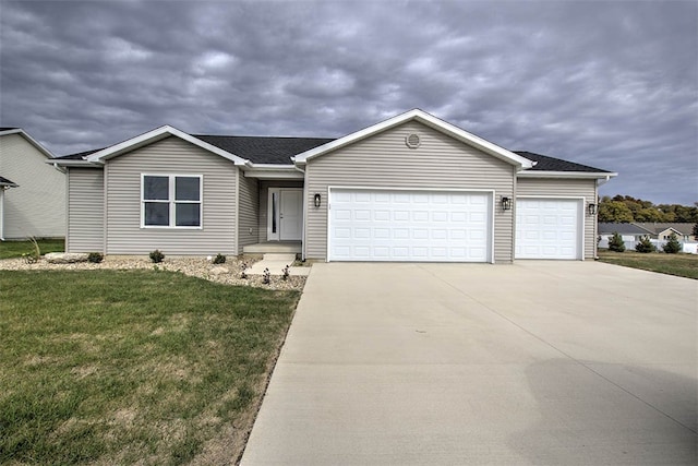 ranch-style house featuring a garage and a front lawn