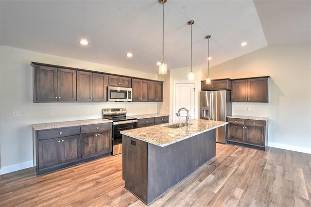 kitchen featuring sink, appliances with stainless steel finishes, dark brown cabinets, and a kitchen island with sink