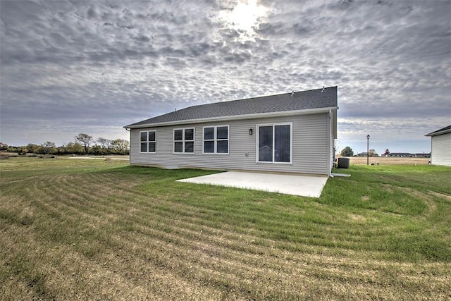 rear view of house featuring a patio and a lawn