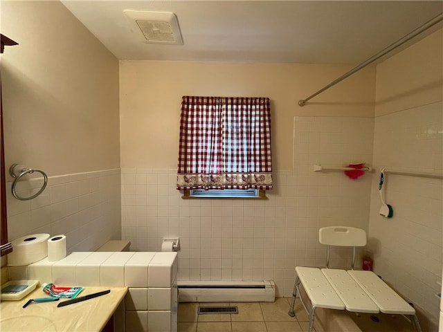 bathroom with tile patterned floors, tile walls, and a baseboard heating unit