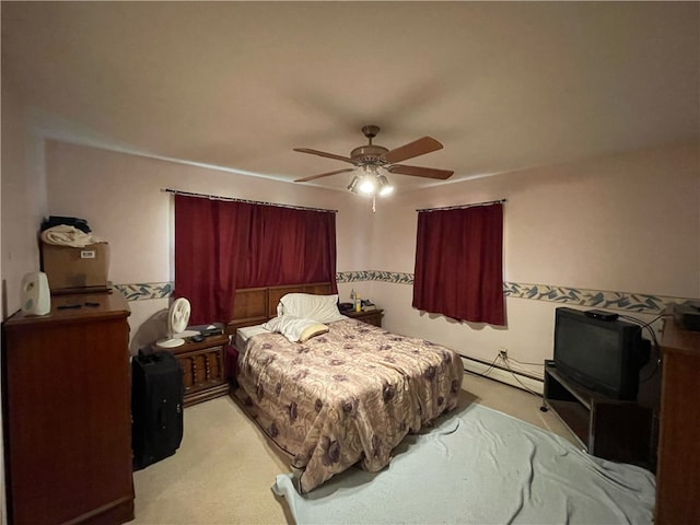 carpeted bedroom featuring baseboard heating and ceiling fan