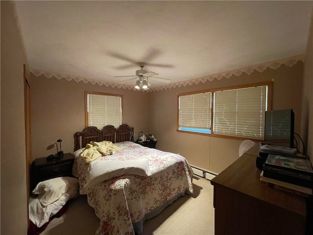 bedroom featuring carpet flooring, ceiling fan, and a baseboard heating unit