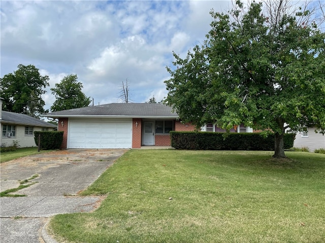 view of front of house with a front yard and a garage