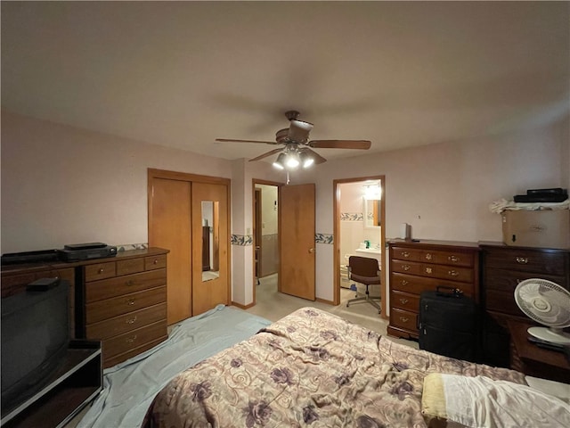 bedroom featuring ceiling fan, light colored carpet, connected bathroom, and a closet