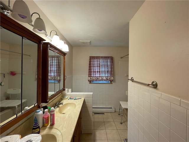 bathroom with tile patterned floors, vanity, tile walls, and a baseboard radiator