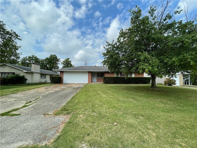 ranch-style house featuring a front lawn and a garage