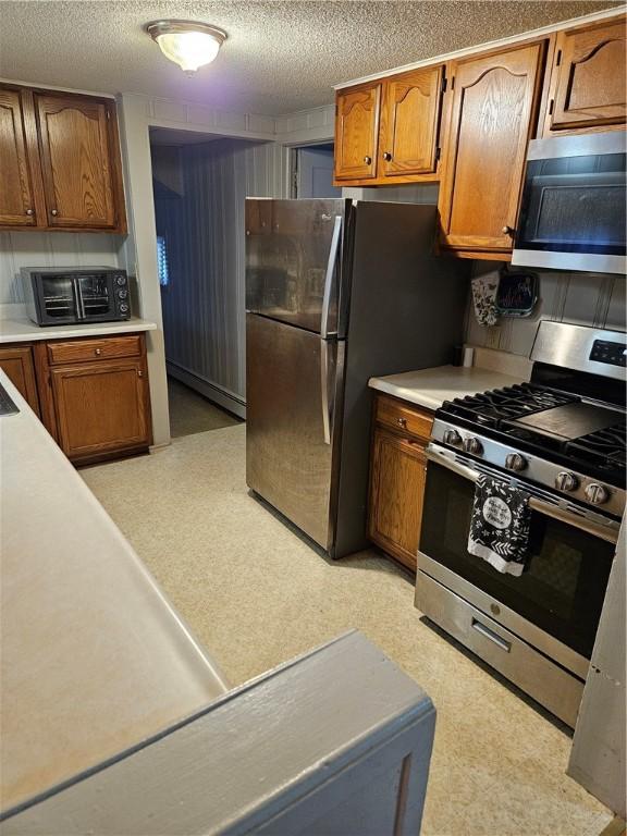 kitchen featuring a textured ceiling and appliances with stainless steel finishes