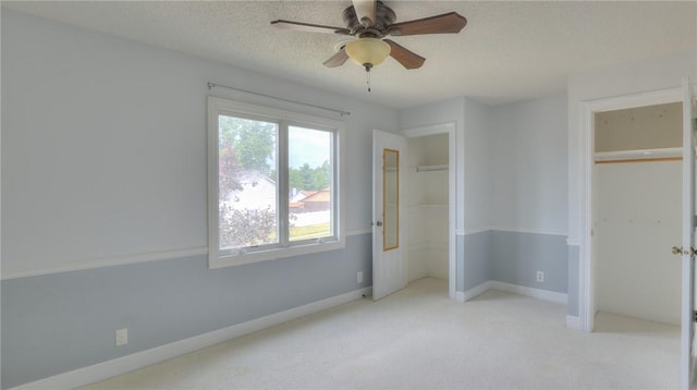 162 S Hillcrest Blvd, Decatur, IL 62522 - unfurnished bedroom with light carpet, a textured ceiling, two closets, and ceiling fan