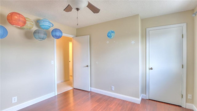 162 S Hillcrest Blvd, Decatur, IL 62522 - unfurnished bedroom featuring wood finished floors, ceiling fan, and a textured ceiling