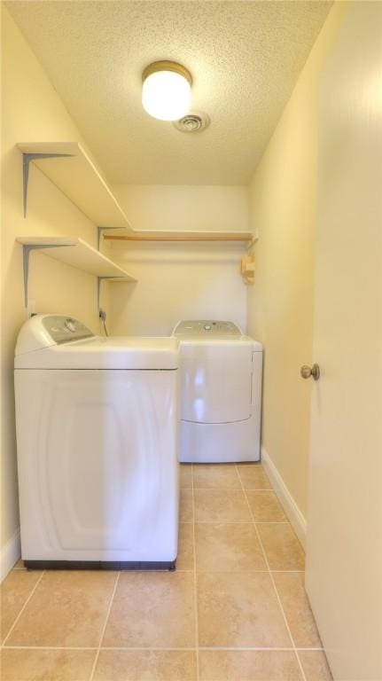 162 S Hillcrest Blvd, Decatur, IL 62522 - washroom featuring washer and clothes dryer, a textured ceiling, and light tile patterned flooring