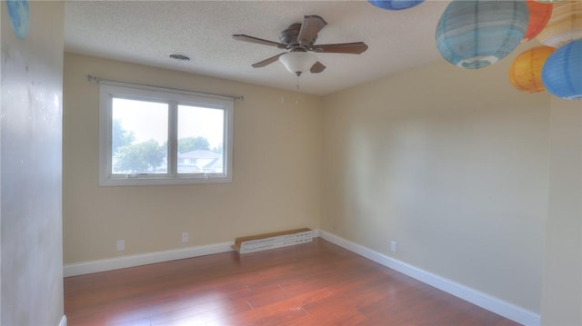 162 S Hillcrest Blvd, Decatur, IL 62522 - spare room with wood finished floors, ceiling fan, and a textured ceiling