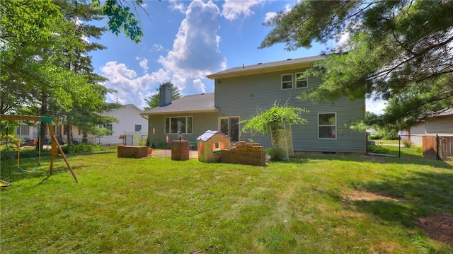 162 S Hillcrest Blvd, Decatur, IL 62522 - back of property featuring a fenced backyard, a chimney, and a playground