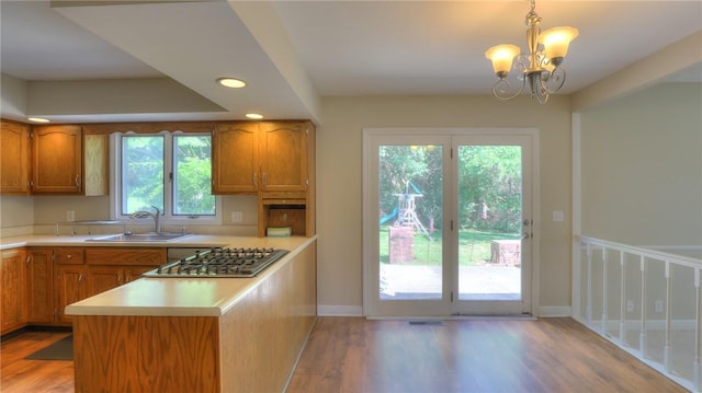 162 S Hillcrest Blvd, Decatur, IL 62522 - kitchen featuring stainless steel gas cooktop, light wood-type flooring, light countertops, brown cabinets, and recessed lighting