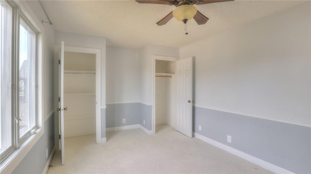 162 S Hillcrest Blvd, Decatur, IL 62522 - unfurnished bedroom with multiple windows, light colored carpet, and ceiling fan