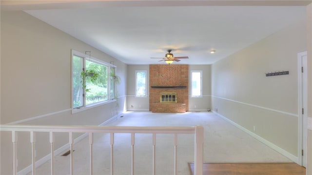 162 S Hillcrest Blvd, Decatur, IL 62522 - unfurnished living room featuring a fireplace, ceiling fan, and light carpet