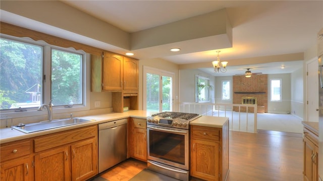 162 S Hillcrest Blvd, Decatur, IL 62522 - kitchen featuring appliances with stainless steel finishes, a peninsula, open floor plan, light wood-type flooring, and light countertops