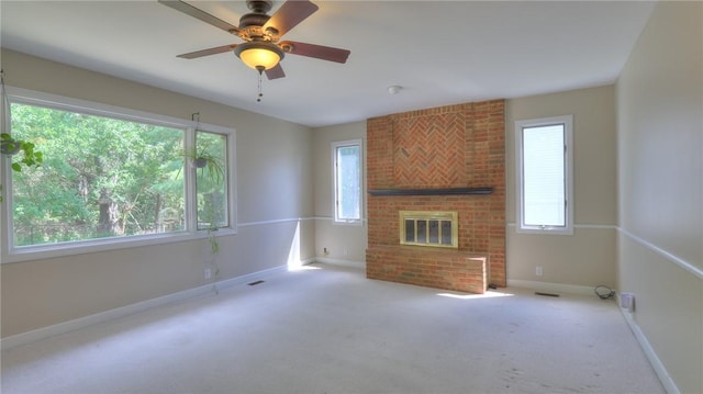 162 S Hillcrest Blvd, Decatur, IL 62522 - unfurnished living room with plenty of natural light, a brick fireplace, carpet flooring, and ceiling fan