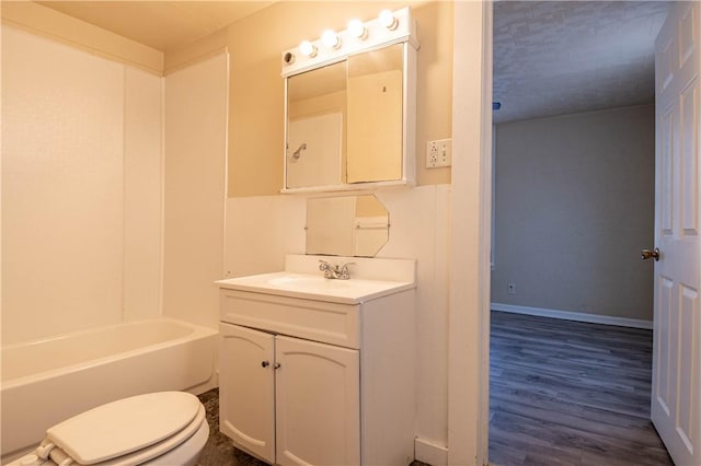 full bathroom featuring baseboards, toilet, wood finished floors, and vanity