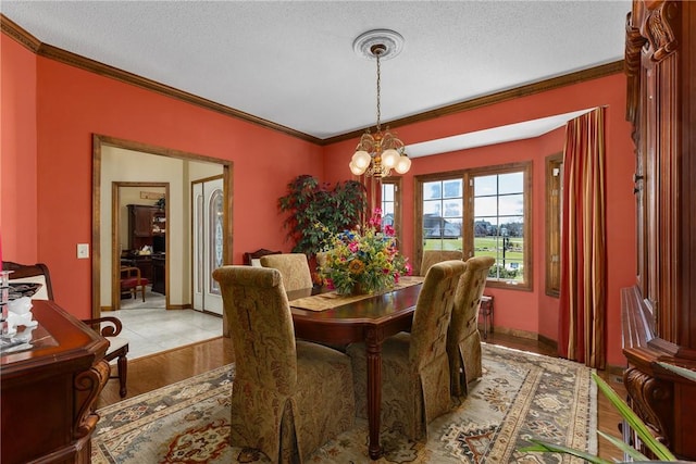 11284 E Lincolnshire Ln, Effingham, IL 62401 - dining space featuring ornamental molding, a chandelier, and a textured ceiling