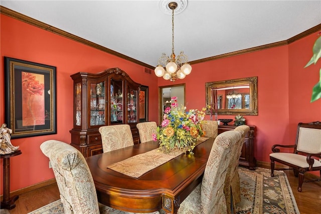 11284 E Lincolnshire Ln, Effingham, IL 62401 - dining space with a chandelier, ornamental molding, baseboards, and wood finished floors