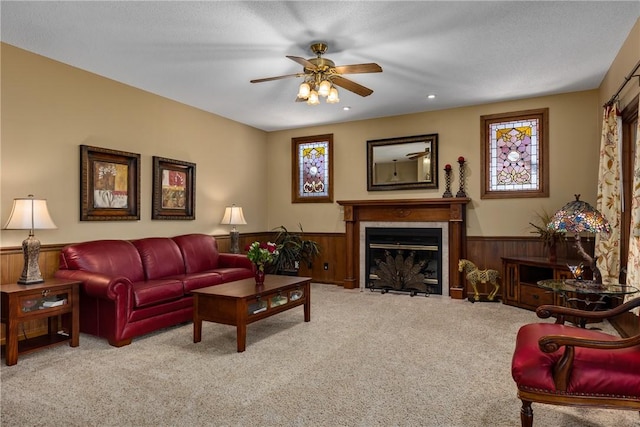 11284 E Lincolnshire Ln, Effingham, IL 62401 - living area with wainscoting, ceiling fan, carpet flooring, a fireplace with flush hearth, and wood walls