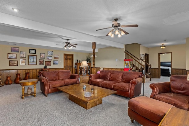 11284 E Lincolnshire Ln, Effingham, IL 62401 - living room featuring carpet, a wainscoted wall, a ceiling fan, stairs, and wood walls