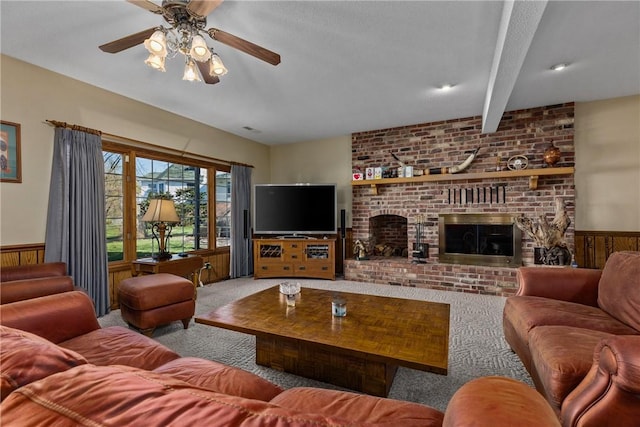 11284 E Lincolnshire Ln, Effingham, IL 62401 - living room featuring a ceiling fan, carpet, wainscoting, a brick fireplace, and beam ceiling