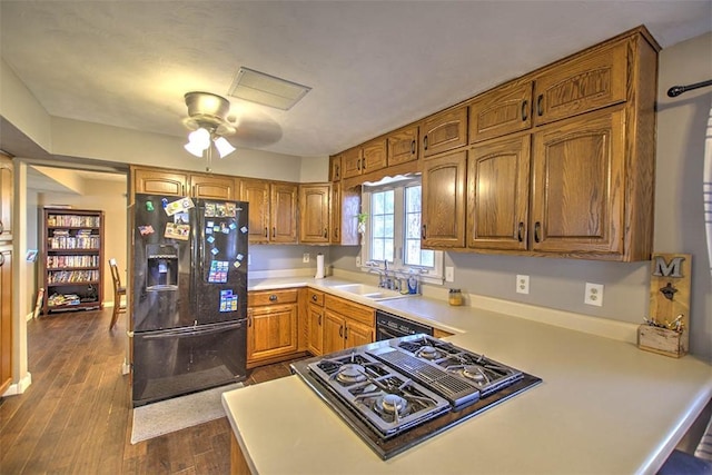 8070 Cerro Gordo Blacktop, Oakley, IL 62501 - kitchen featuring stovetop with downdraft, a sink, black refrigerator with ice dispenser, brown cabinetry, and light countertops