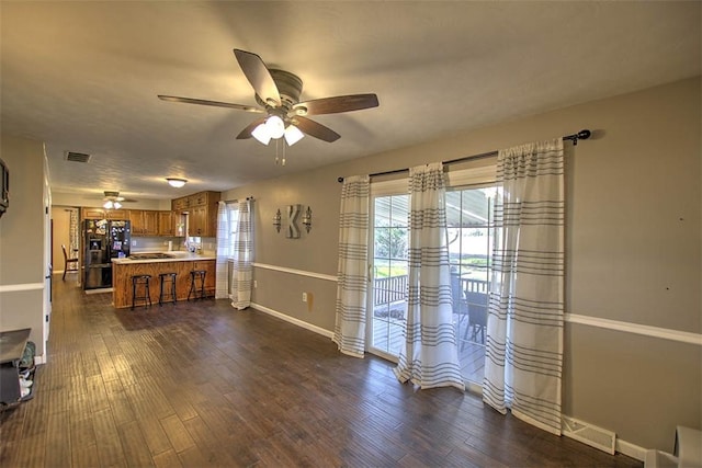 8070 Cerro Gordo Blacktop, Oakley, IL 62501 - living area featuring ceiling fan, baseboards, dark wood-type flooring, and visible vents