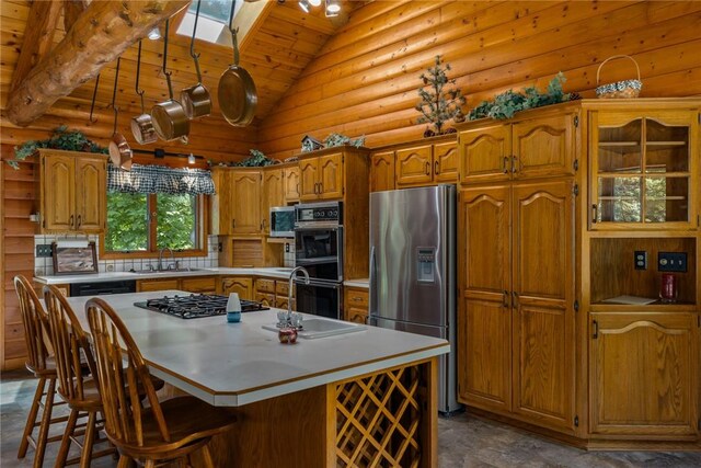5446 N 1700th St, Dieterich, IL 62424 - kitchen featuring stainless steel appliances, a skylight, lofted ceiling, a center island, and brown cabinetry