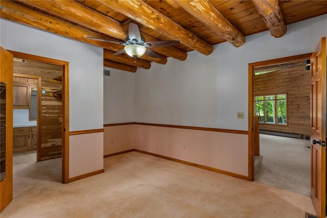 5446 N 1700th St, Dieterich, IL 62424 - empty room featuring a wood ceiling with exposed beams, light carpet, a baseboard radiator, a ceiling fan, and wooden walls