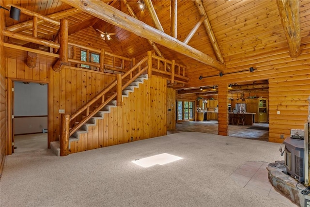 5446 N 1700th St, Dieterich, IL 62424 - unfurnished living room with a wooden ceiling with exposed beams, a wood stove, carpet, stairs, and high vaulted ceiling