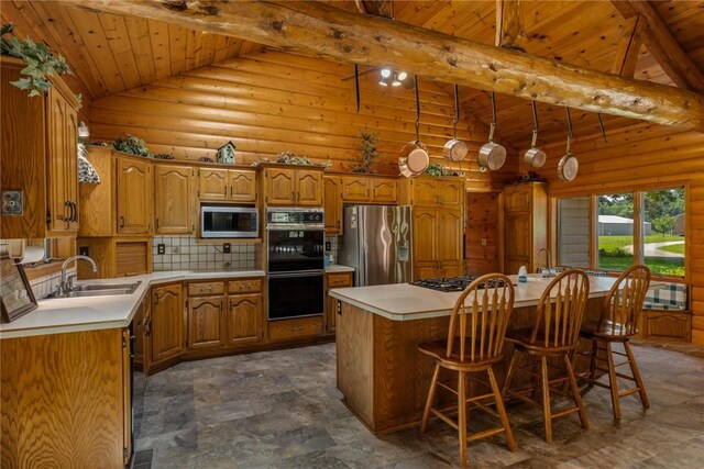 5446 N 1700th St, Dieterich, IL 62424 - kitchen featuring appliances with stainless steel finishes, a wooden ceiling with exposed beams, a kitchen island, brown cabinets, and light countertops
