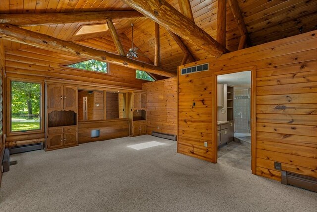 5446 N 1700th St, Dieterich, IL 62424 - unfurnished living room featuring a wooden ceiling with exposed beams, baseboard heating, plenty of natural light, carpet floors, and wood walls