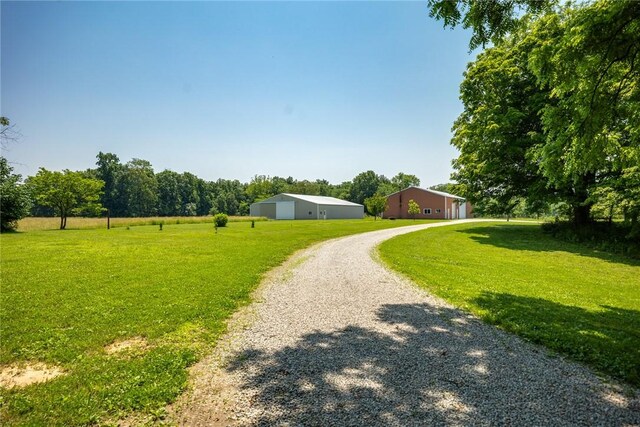 5446 N 1700th St, Dieterich, IL 62424 - view of grassy yard with driveway, an outbuilding, and an outdoor structure