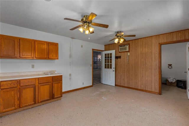 5446 N 1700th St, Dieterich, IL 62424 - kitchen with brown cabinetry, a ceiling fan, wood walls, light countertops, and a wall unit AC