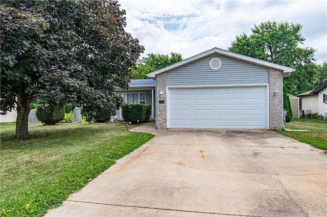 130 S Illinois St, Warrensburg, IL 62573 - view of front of house featuring brick siding, a front lawn, concrete driveway, and an attached garage