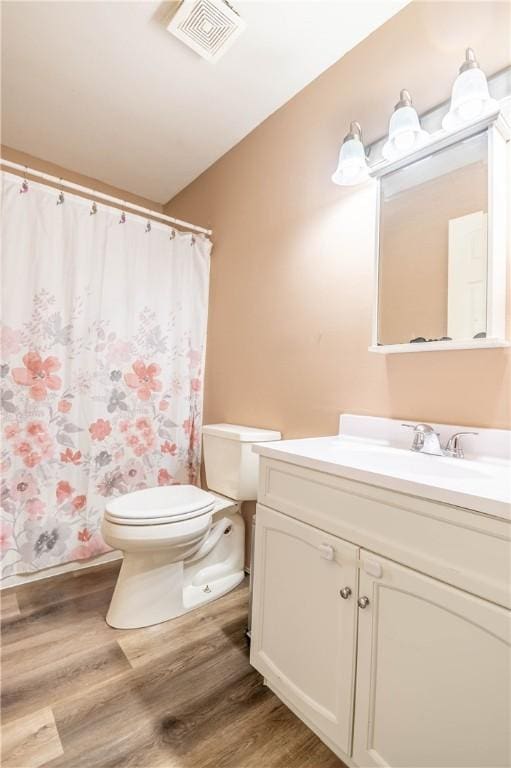 130 S Illinois St, Warrensburg, IL 62573 - bathroom with vanity, wood finished floors, and curtained shower