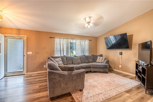 130 S Illinois St, Warrensburg, IL 62573 - living area featuring wood finished floors, a ceiling fan, and vaulted ceiling