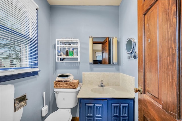 half bath featuring toilet and vanity