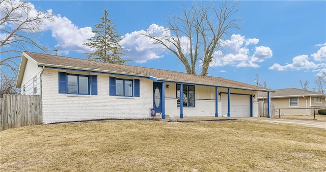 ranch-style house with a garage, brick siding, a front yard, and fence