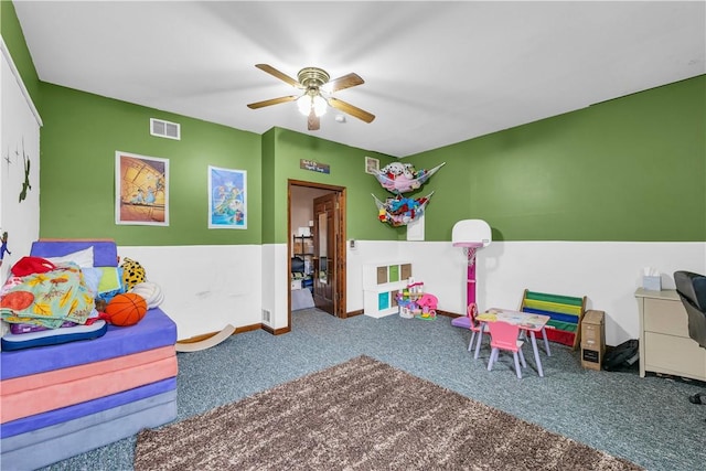 rec room with ceiling fan, carpet flooring, visible vents, and baseboards