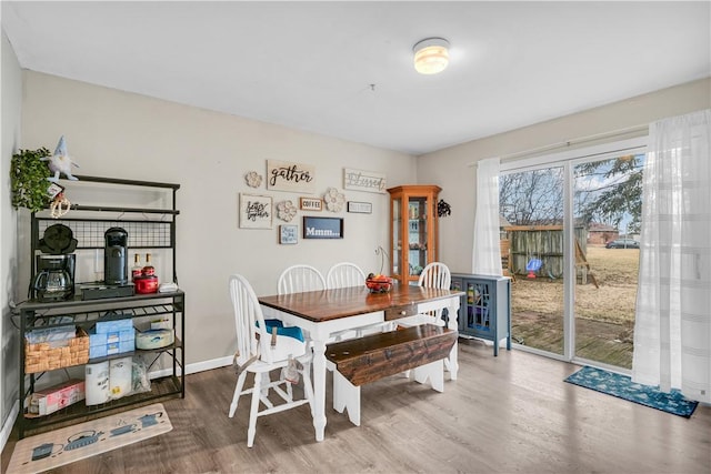 dining room featuring baseboards and wood finished floors