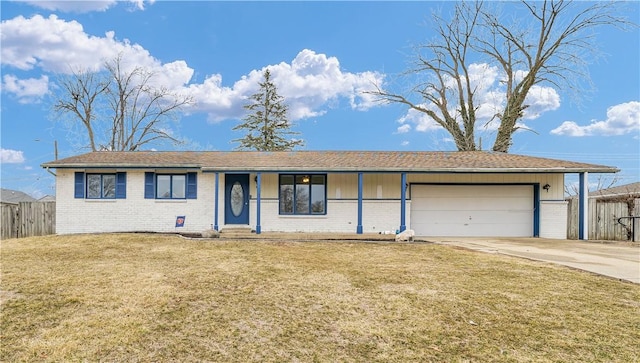 ranch-style home featuring a garage, a front yard, brick siding, and fence