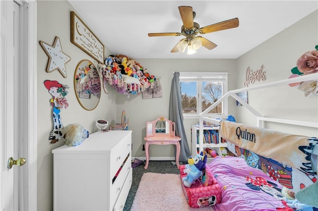 carpeted bedroom featuring a ceiling fan and baseboards