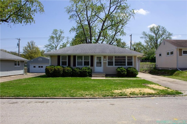 view of front of house with a garage, a front yard, entry steps, an outbuilding, and concrete driveway